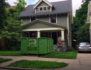 Dumpster on Grand Rapids House Walkway