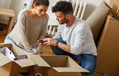 Woman and man unpacking a box