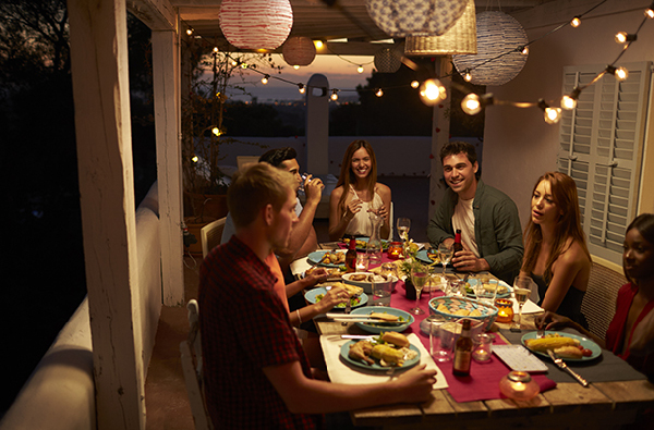 Fairy lights over a patio with friends